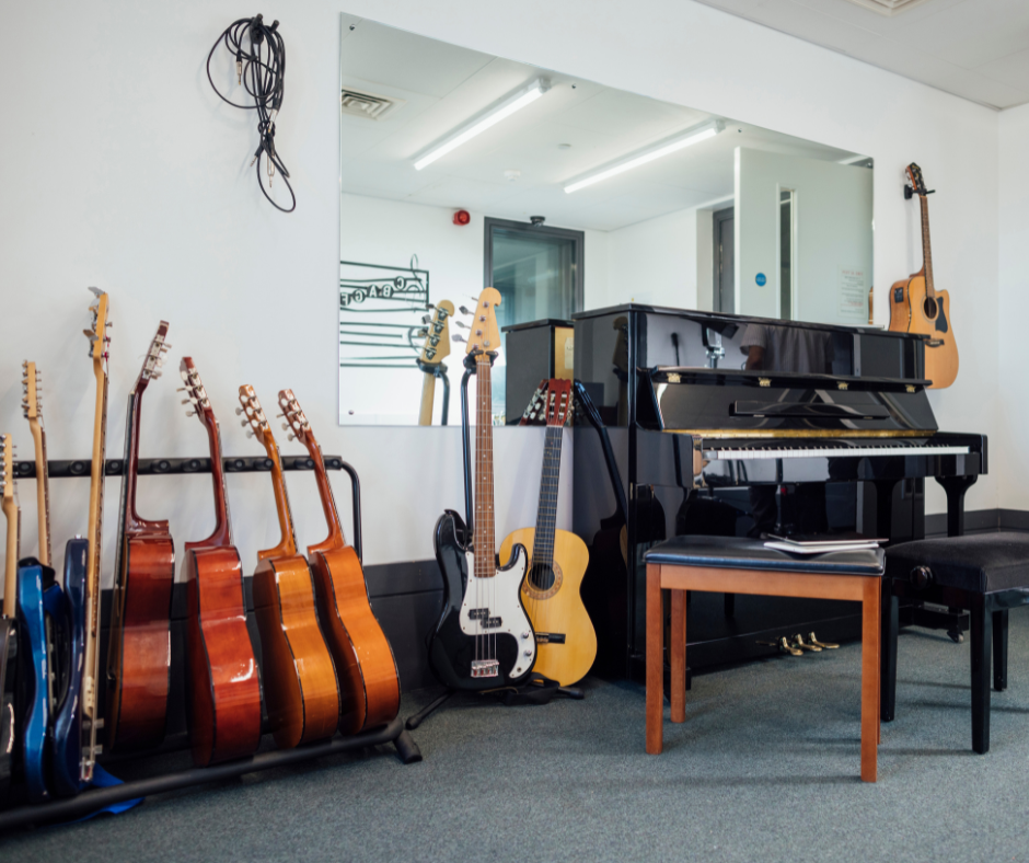 Music room with guitars, a bass, and a piano.