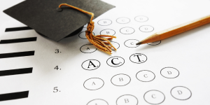 ACT multiple-choice answer sheet with a pencil and graduation cap tassel.